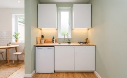 Compact 5x5 kitchenette with single-wall layout showing under-counter fridge, sink, and two-burner hob