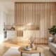 Studio apartment with a slatted wooden screen partition separating the kitchen from the living area